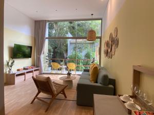 a living room with a couch and a large window at Ozone Cave in Thong Nai Pan Noi