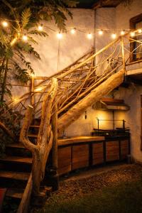 a room with a staircase and a table with lights at Cabaña en la Calera el Pinar in La Calera