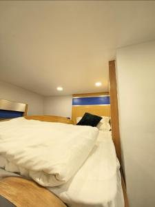 a bedroom with two beds with white sheets at #MyPawsomeGetaway, Fun Family Retreat, Tanah Rata, Cameron Highlands in Tanah Rata