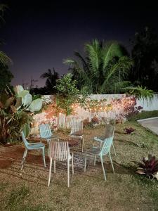 a group of chairs and a table in the grass at Norwil Manor Tagaytay in Tagaytay