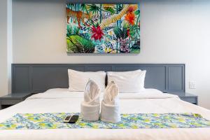 a pair of shoes sitting on top of a bed at Xanadu Hotel Utapao in Rayong +88 photos