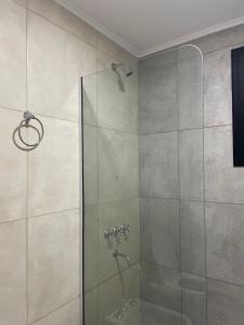 a bathroom with a shower with a glass door at YOJU aparthotel in Colón +60 photos