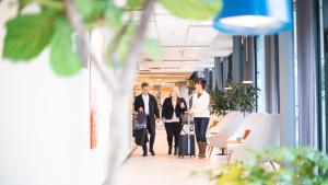 a group of people walking down an office hallway at Courtyard Tampere City in Tampere