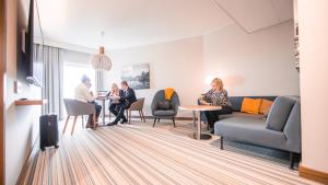 a group of people sitting at a table in a waiting room at Courtyard Tampere City in Tampere +67 photos