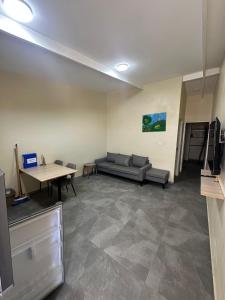 a living room with a couch and a table at Curasita Colour Appartments & Resort - adres kaya Sucre nst 282 in Willemstad
