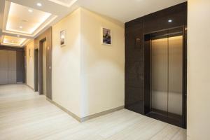 a hallway with a elevator in a building at asar Varanasi Junction by Orion Hotels in Varanasi