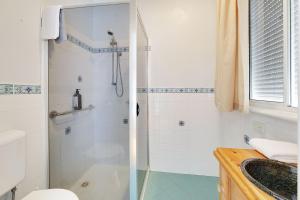a bathroom with a shower and a toilet and a sink at Morrissey Cottage in Warrnambool +10 photos