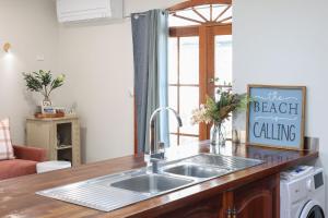 a kitchen with a sink and a counter top at Morrissey Cottage in Warrnambool