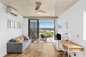 a living room with a couch and a table at Direct Collective - Pavilion and Governor on Brookes in Brisbane