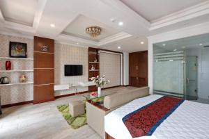 a bedroom with a large bed and a tv at Eco Nest Signature Hotel in Hanoi