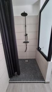 a shower with a black shower curtain in a bathroom at Villa Horizon Volcan in Saint-Philippe +11 photos