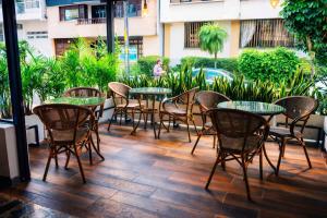 a group of tables and chairs on a patio at Hotel Cafe Boutique in Pereira