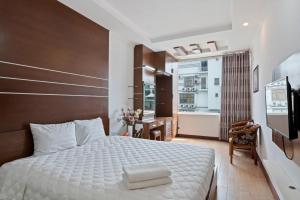 a bedroom with a large white bed and a balcony at Eco Nest Signature Hotel in Hanoi +13 photos
