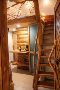a spiral staircase in a log cabin at Cabaña en la Calera el Pinar in La Calera