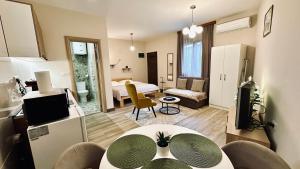 a living room with a room with a bed at Central Station Apartments in Podgorica