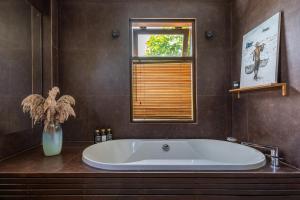 a large tub in a bathroom with a window at Nami House Balian in Balian +27 photos