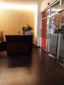 an office lobby with a desk and a glass door at Hotel O Friend in Petaling Jaya