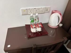 a table with two bottles of water and a blender at Hotel O Friend in Petaling Jaya +12 photos