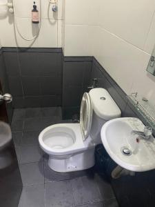 a bathroom with a toilet and a sink at Hotel O Friend in Petaling Jaya