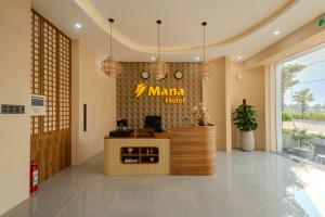 a lobby with a mama hotel sign on the wall at Mana Hotel Quảng Bình in Dong Hoi