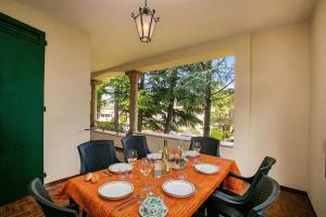 a dining room table with chairs and a large window at Villa Alberti 900m from Garda lake with Garden in Salò