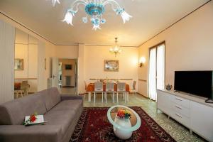 a living room with a couch and a television at Villa Alberti 900m from Garda lake with Garden in Salò +30 photos