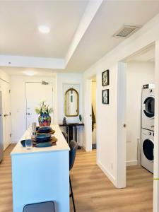 a kitchen with white walls and a white counter top at Downtown Condo, Stylish Comfy in Calgary