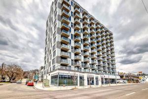 a tall building with balconies on the side of a street at Downtown Condo, Stylish Comfy in Calgary