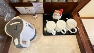 a wooden box with four white dishes on a table at Heritage Hotel Cameron Highlands in Cameron Highlands +74 photos