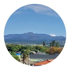 a view of a mountain in the distance at The upper room디어퍼룸 in Mahŭl-tong +6 photos