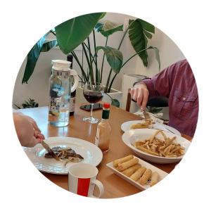 a person sitting at a table with a plate of food at The upper room디어퍼룸 in Mahŭl-tong
