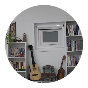 a mirror of a room with two guitars and a television at The upper room디어퍼룸 in Mahŭl-tong