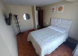 a bedroom with a large bed in a room at Apart colección cusco in Cusco