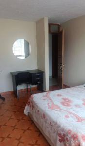 a bedroom with a desk and a bed and a desk sidx sidx sidx at Apart colección cusco in Cusco