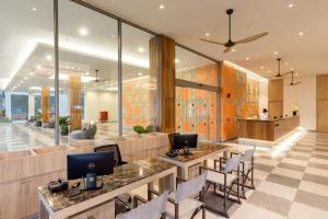 a lobby with two tables and chairs and a counter at X10 Khaolak Resort in Khao Lak