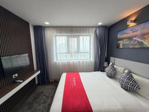 a bedroom with a large bed and a television at Ha Long 2BR Apartment - Spacious & Modern - Near Center in Ha Long +47 photos