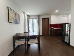 a kitchen and dining room with a table and chairs at Ha Long 2BR Apartment - Spacious & Modern - Near Center in Ha Long