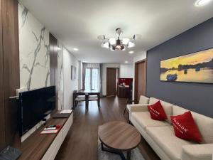 a living room with a couch and a flat screen tv at Ha Long 2BR Apartment - Spacious & Modern - Near Center in Ha Long