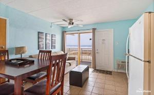 a kitchen and dining room with a table and a refrigerator at 1 Bedroom Beach Condo with a Pool & Balcony in Wildwood Crest