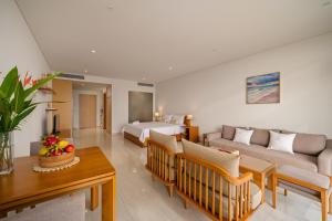 a living room with a couch and a bed at The Bada studio apartment - ocean view in Danang