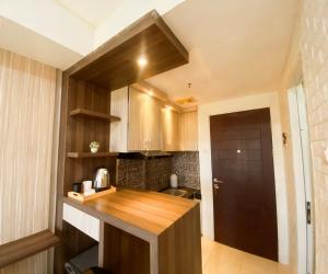 a kitchen with wooden cabinets and a wooden counter top at M Apartement in Seturan