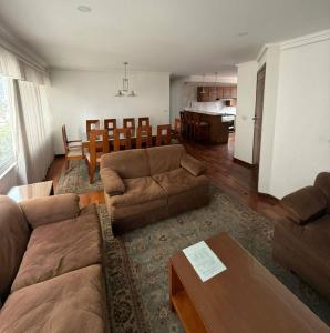 a living room with a couch and a table at El departamento de manolo in Cusco