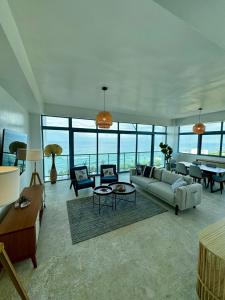 a living room with a couch and a table at JUAN DOLIO 2BR Beach front SALITRE across Club Hemingway in Juan Dolio +59 photos
