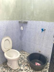 a bathroom with a toilet in a tiled room at LovKend in Ruteng +42 photos