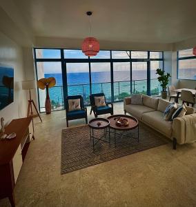 a living room with a couch and a view of the ocean at JUAN DOLIO 2BR Beach front SALITRE across Club Hemingway in Juan Dolio