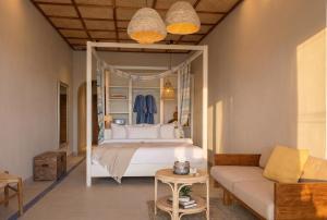 a bedroom with a large bed and a couch at Baan Jai Dee Beach Front Hotel in Wok Tum +43 photos