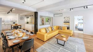 a living room with a table and a yellow couch at AZA Motel in Lismore