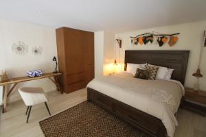 a bedroom with a bed and a desk and a chair at Luxury Jungle Loft, 7 Pools, Rooftop Panoramic View, Beach Shuttle, Fast WiFi in Tulum +51 photos