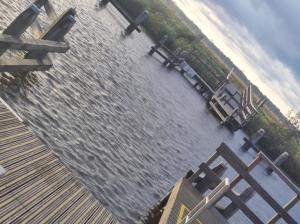 a view of a body of water with a dock at Huis-Meerwijck in Kropswolde