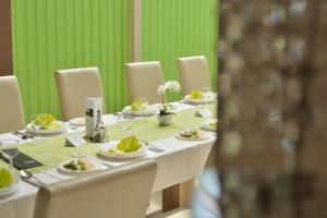 a long table with plates of food on it at Viktória Wellness Hotel in Nagyatád +41 photos